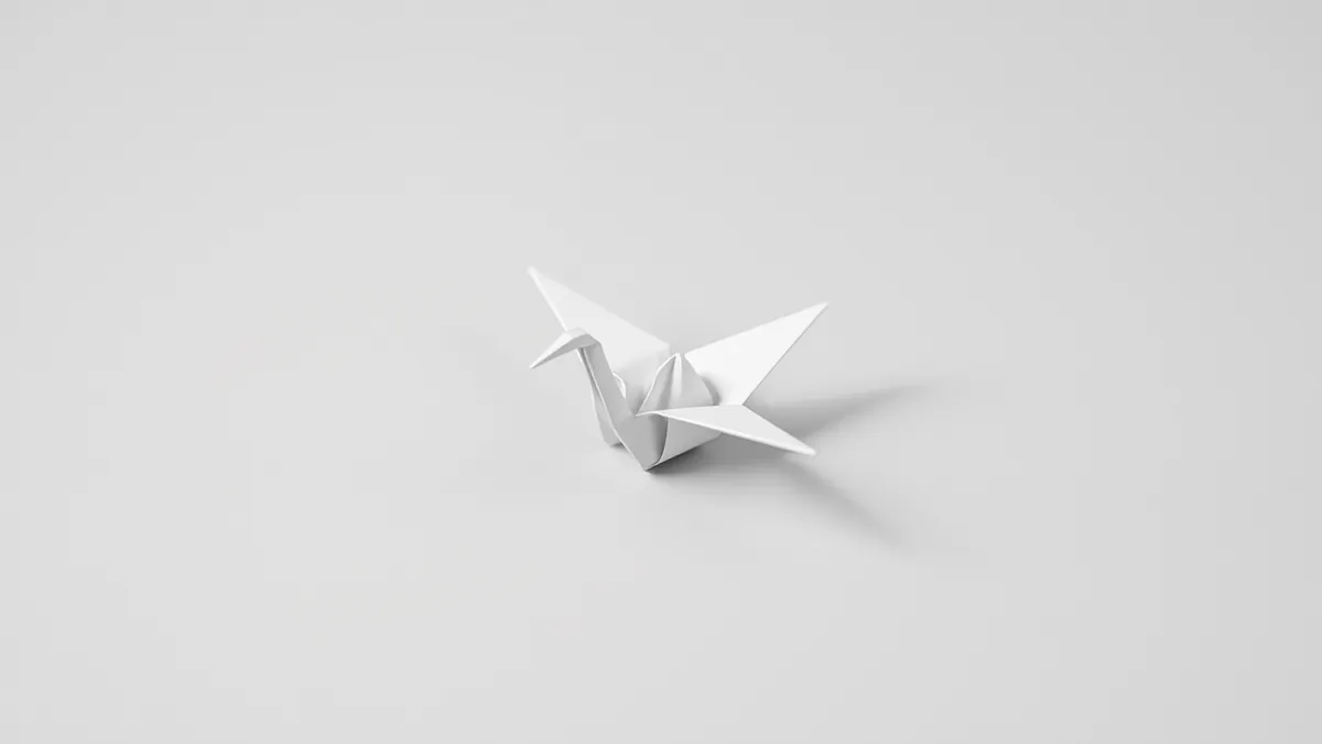 Biały origami żuraw na jasnoszarym tle – prostota rozliczeń na ryczałcie